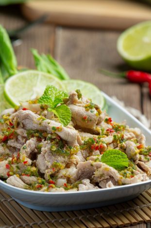 Spicy Pork Salad Served with fresh crispy kale stalks Thai food.